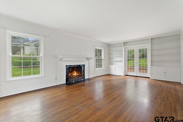 2318 S Chilton Ave, Tyler, TX 75701 - unfurnished living room with a high end fireplace, wood-type flooring, built in shelves, french doors, and ornamental molding
