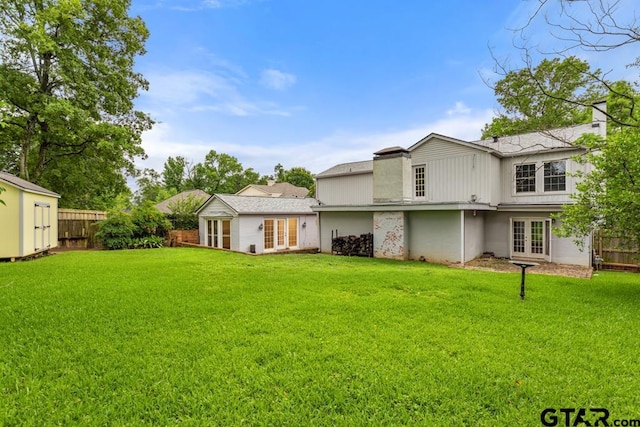 2318 S Chilton Ave, Tyler, TX 75701 - back of property featuring french doors, a fenced backyard, a shed, and a chimney