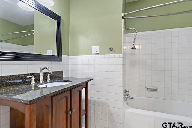 2318 S Chilton Ave, Tyler, TX 75701 - full bathroom with vanity, shower / bath combination, and tile walls