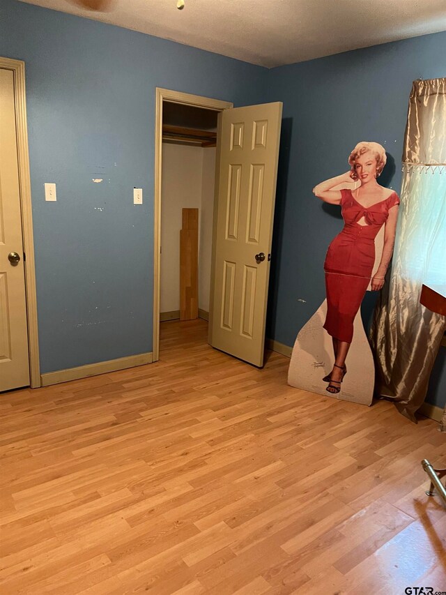 unfurnished bedroom with light wood-type flooring