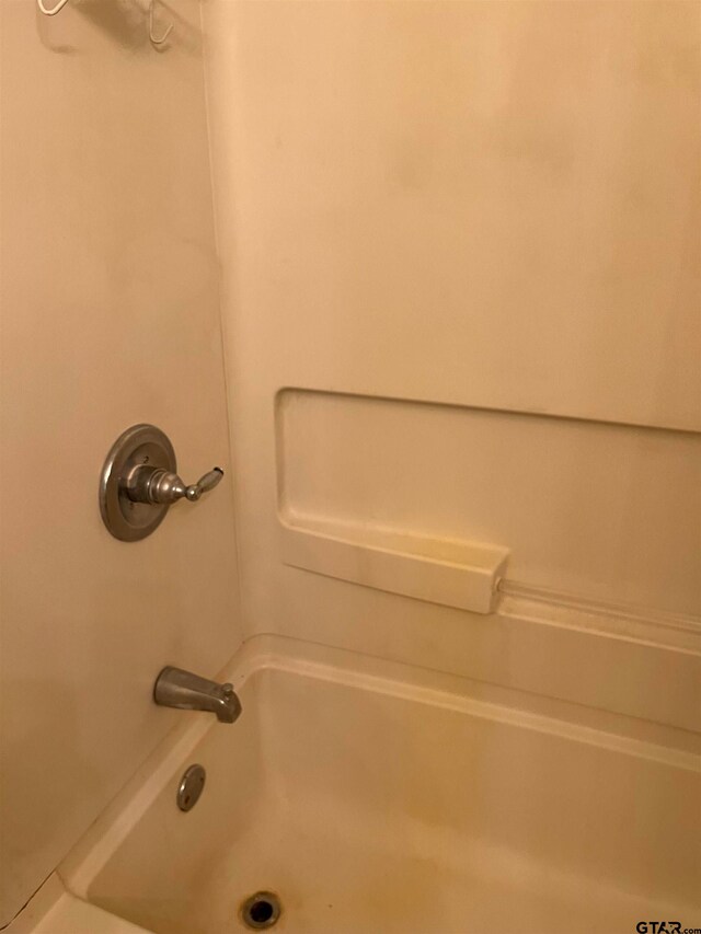 bathroom with shower / tub combination