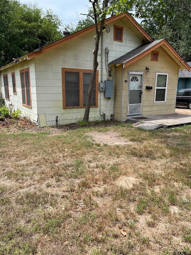 rear view of house featuring a yard and a patio area