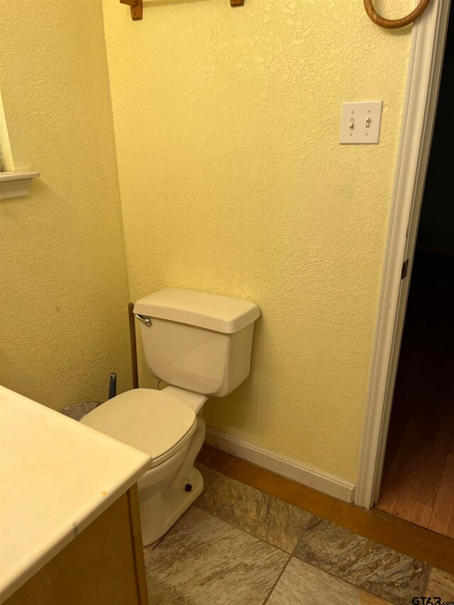 bathroom featuring toilet, vanity, and tile patterned flooring