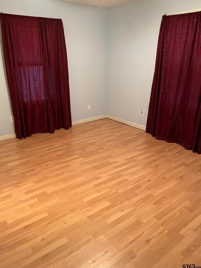 unfurnished room featuring light hardwood / wood-style flooring