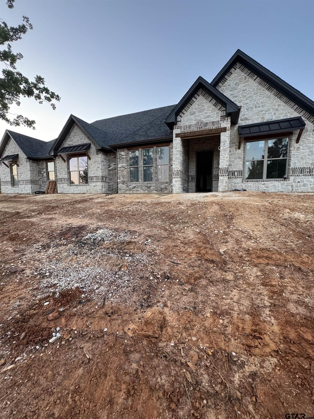 12336 Oak Grove Dr, Lindale Isd Tyler, TX 75706 - french country style house featuring stone siding, brick siding, and roof with shingles