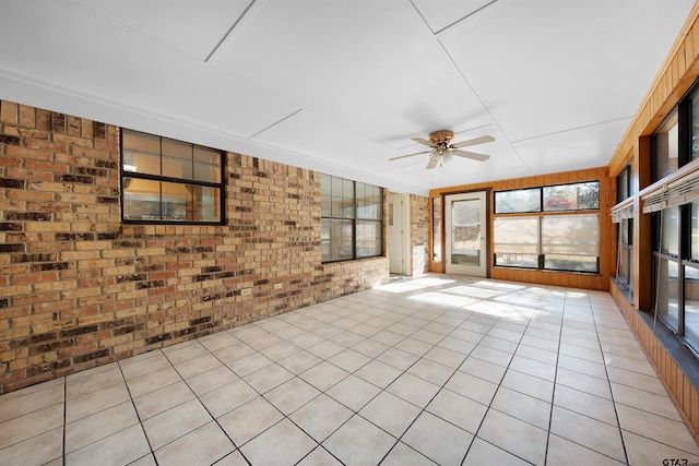 unfurnished sunroom with ceiling fan