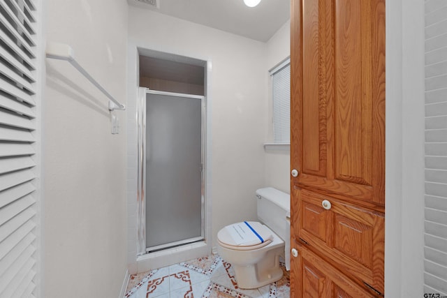 bathroom featuring toilet, tile patterned floors, and walk in shower