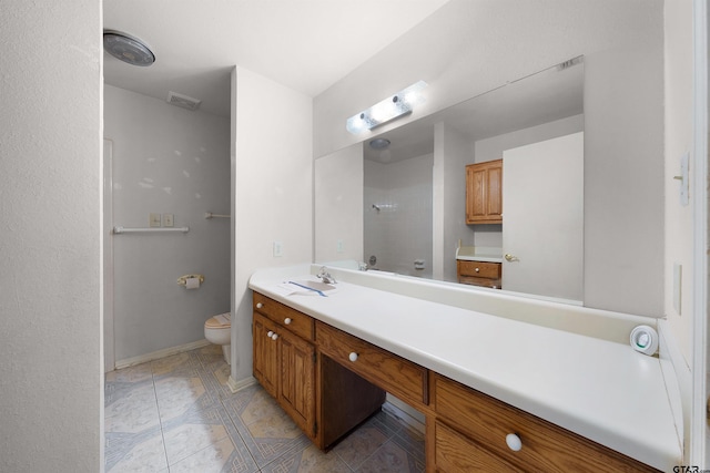 bathroom featuring toilet and vanity