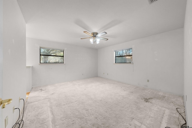 empty room featuring ceiling fan and a healthy amount of sunlight