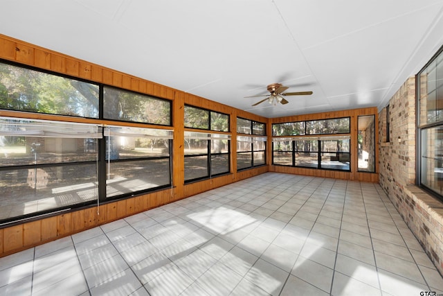 unfurnished sunroom with ceiling fan