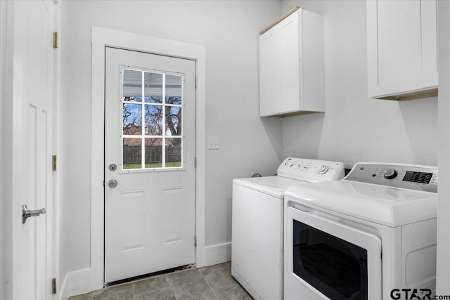 laundry room with independent washer and dryer and cabinets