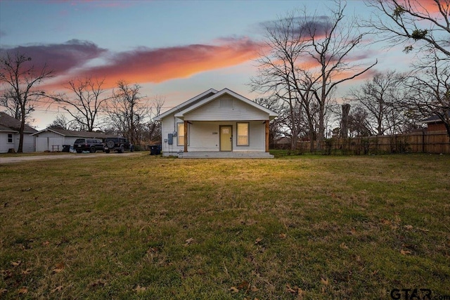 view of front of home with a porch and a lawn