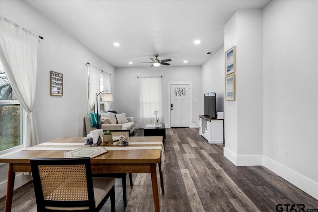 dining space with dark wood-type flooring, a wealth of natural light, and ceiling fan