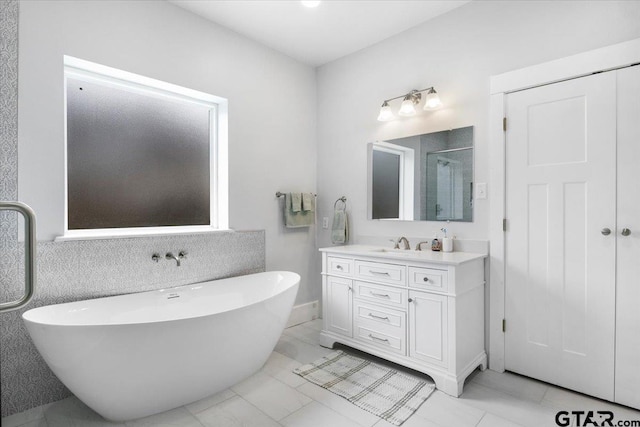 bathroom with vanity, tile patterned flooring, and plus walk in shower