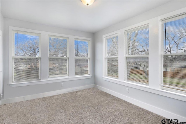 unfurnished sunroom with plenty of natural light