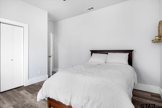 bedroom featuring wood-type flooring and a closet