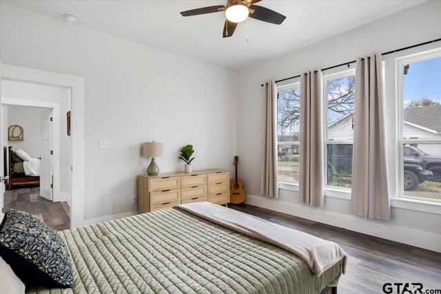 bedroom with dark hardwood / wood-style floors and ceiling fan