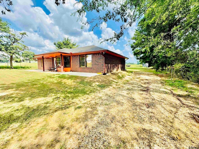 exterior space with a yard and a patio area