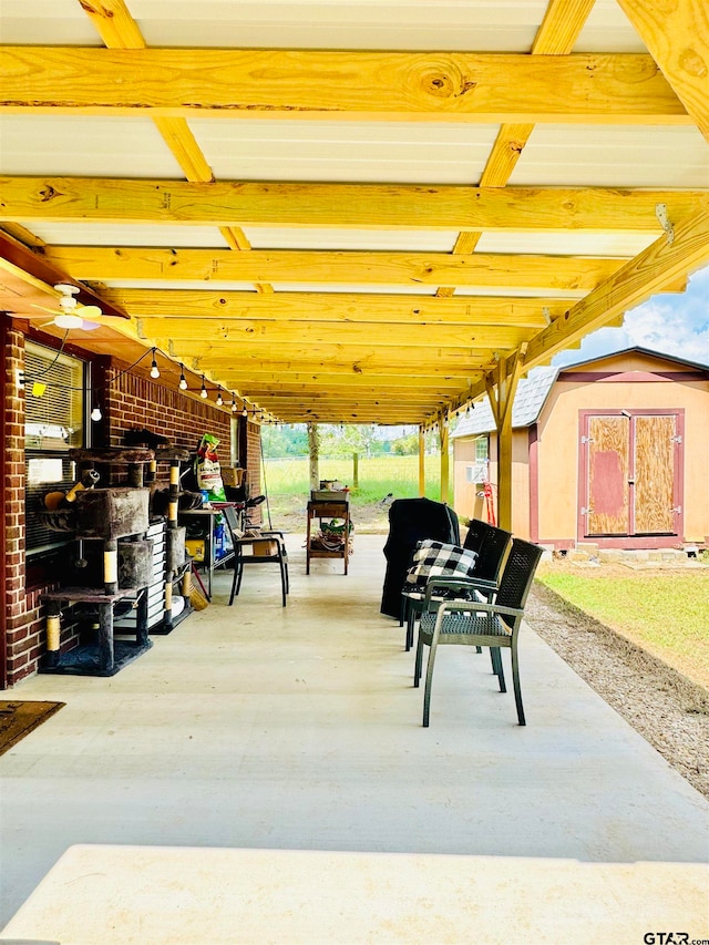 view of patio / terrace featuring a storage shed and ceiling fan