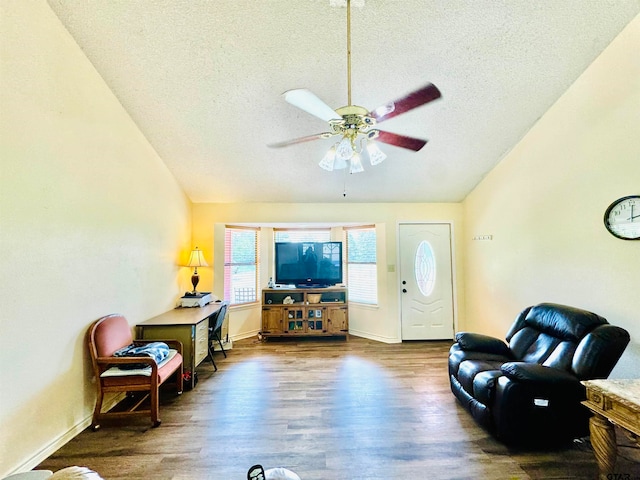 living room featuring ceiling fan, dark hardwood / wood-style floors, a textured ceiling, and vaulted ceiling