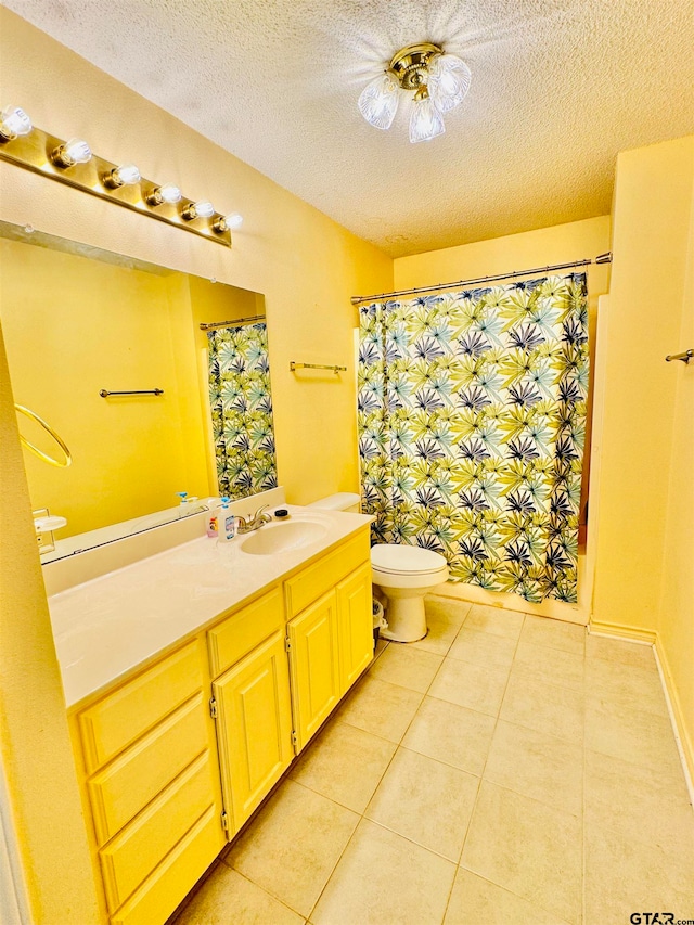 bathroom with a shower with shower curtain, a textured ceiling, vanity, tile patterned floors, and toilet