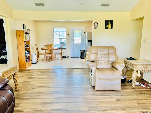 living room with vaulted ceiling and light hardwood / wood-style flooring