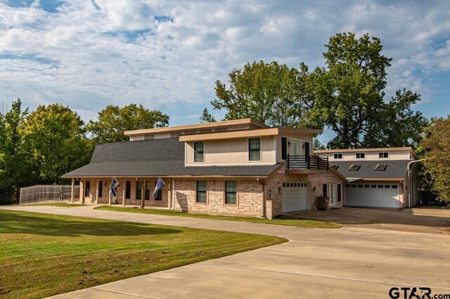 200 County Road 1520, Mount Pleasant, TX 75455 - view of front of home with driveway, fence, a porch, a front yard, and a garage