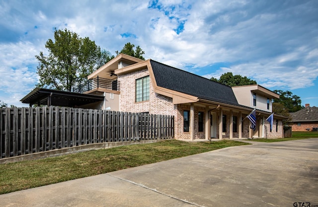 200 County Road 1520, Mount Pleasant, TX 75455 - view of front of property featuring a front lawn, covered porch, fence, brick siding, and roof with shingles