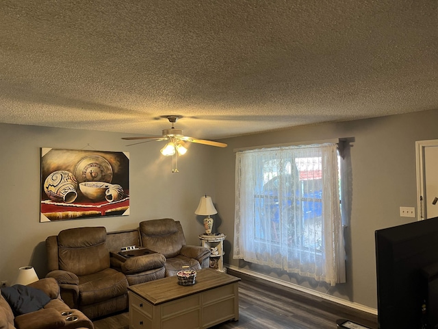 219 Lockhart St, Pittsburg, TX 75686 - living area with a textured ceiling, dark wood-type flooring, and a ceiling fan