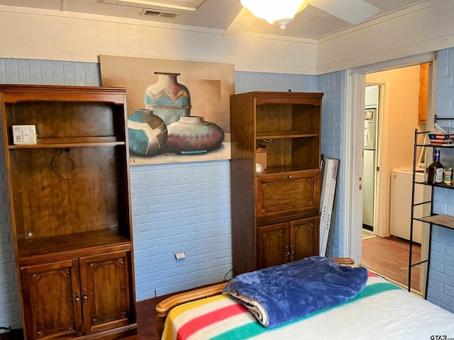 219 Lockhart St, Pittsburg, TX 75686 - bedroom featuring wood finished floors and washer / clothes dryer