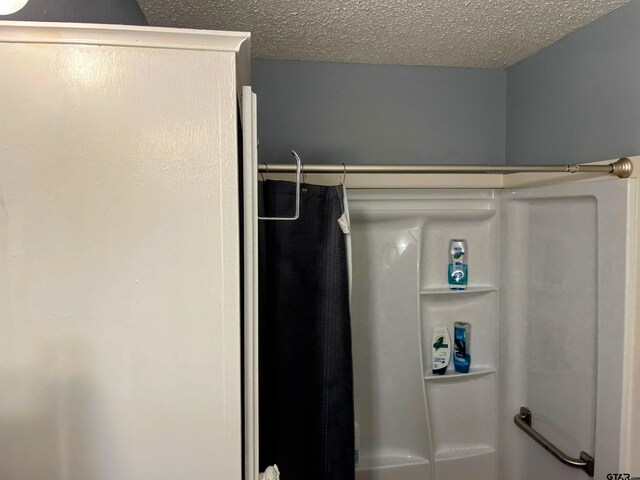 219 Lockhart St, Pittsburg, TX 75686 - full bathroom with a shower with curtain and a textured ceiling