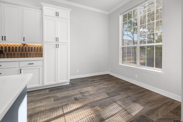 3827 Scenic Dr, Tyler, TX 75709 - unfurnished dining area featuring ornamental molding, baseboards, plenty of natural light, and dark wood-style flooring
