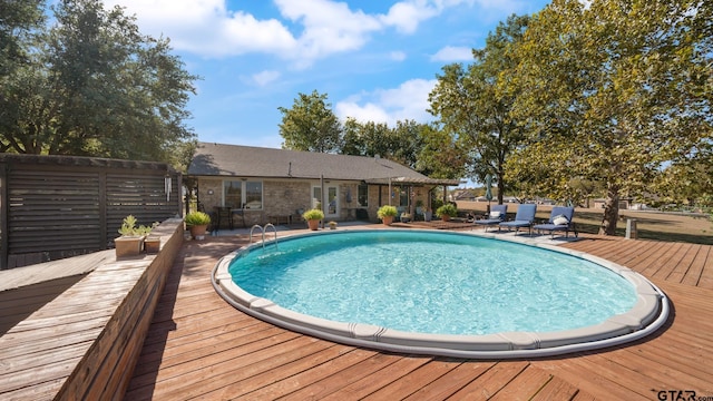 view of pool with a wooden deck