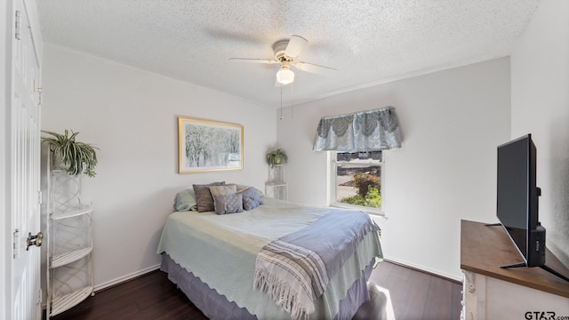 bedroom featuring ceiling fan, dark hardwood / wood-style flooring, and a textured ceiling