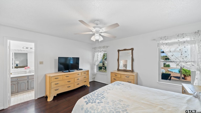 bedroom with ceiling fan, dark hardwood / wood-style flooring, ensuite bath, and a textured ceiling