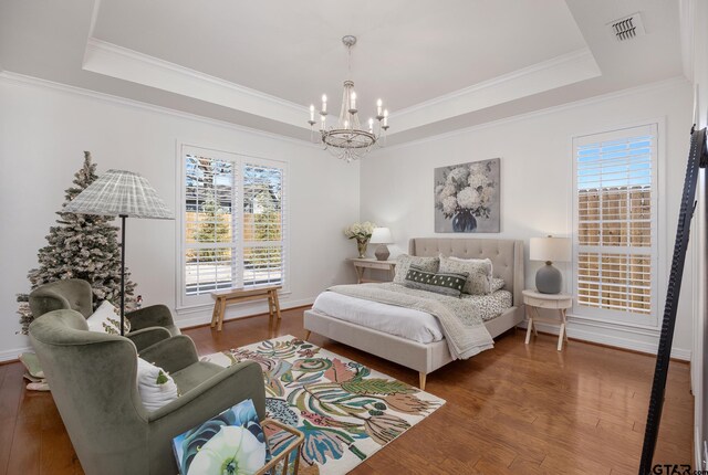 110 Carmel, Bullard, TX 75757 - bedroom featuring a tray ceiling, a chandelier, wood finished floors, crown molding, and baseboards