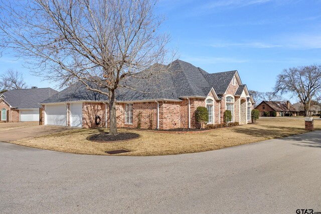 110 Carmel, Bullard, TX 75757 - french provincial home with an attached garage, brick siding, driveway, a front lawn, and a shingled roof