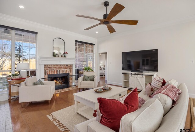 110 Carmel, Bullard, TX 75757 - living area featuring a brick fireplace, crown molding, ceiling fan, wood finished floors, and recessed lighting