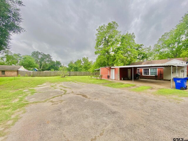 710 N 6th St, Crockett, TX 75835 - exterior space featuring fence and a carport
