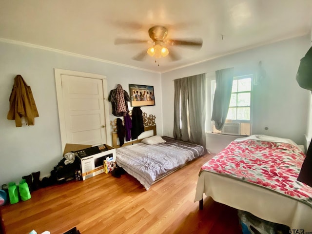 710 N 6th St, Crockett, TX 75835 - bedroom featuring ornamental molding, cooling unit, a ceiling fan, and wood finished floors