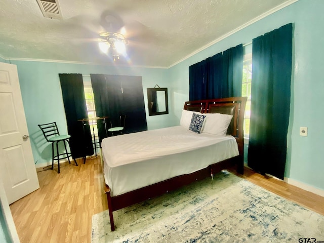 710 N 6th St, Crockett, TX 75835 - bedroom featuring crown molding, light wood-style flooring, visible vents, and multiple windows