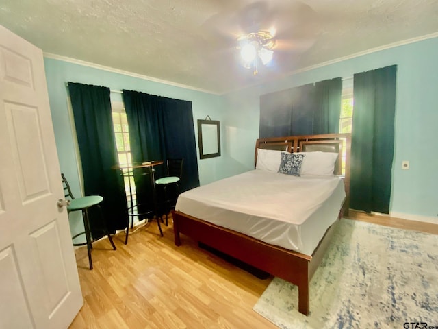 710 N 6th St, Crockett, TX 75835 - bedroom featuring baseboards, ornamental molding, and wood finished floors