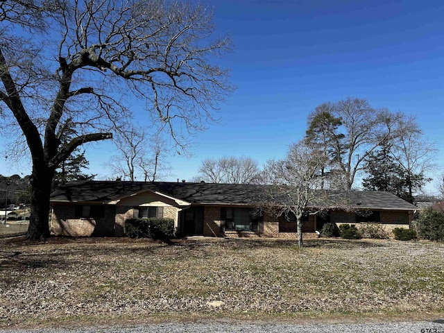 single story home featuring brick siding