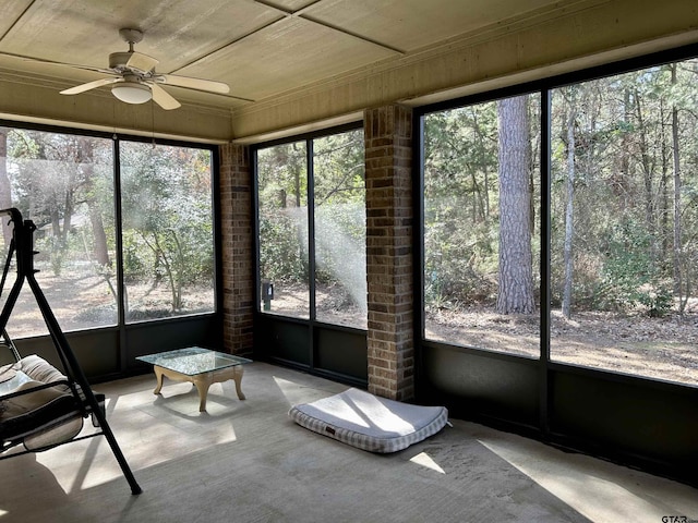 unfurnished sunroom with a ceiling fan