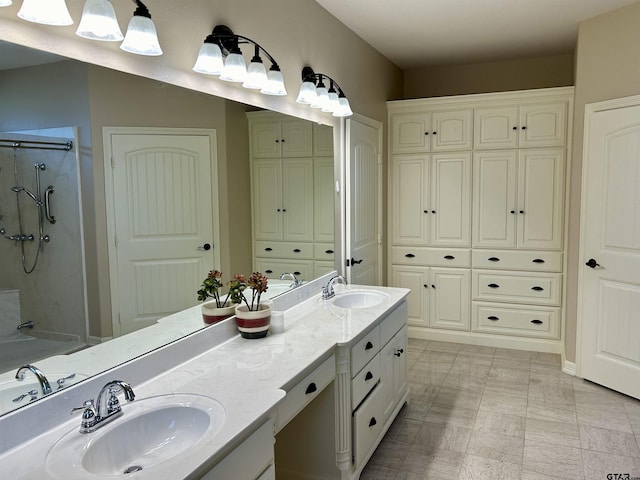 full bath featuring double vanity, a sink, and an enclosed shower