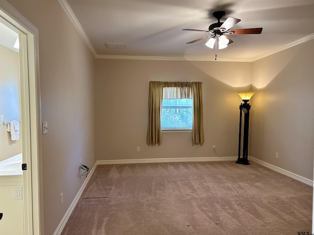 carpeted empty room featuring baseboards, a ceiling fan, and crown molding