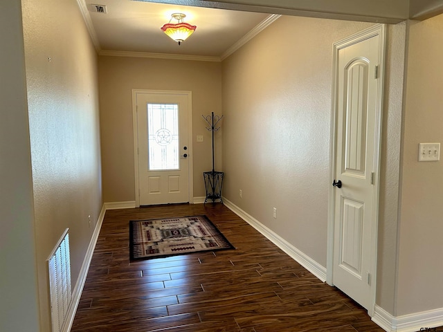 foyer entrance with baseboards, visible vents, dark wood-style flooring, and ornamental molding