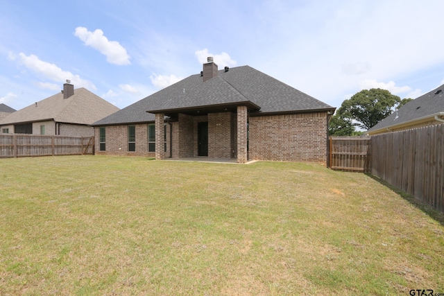 11747 Jayden Ln, Tyler, TX 75703 - back of house featuring brick siding, a fenced backyard, a shingled roof, and a chimney
