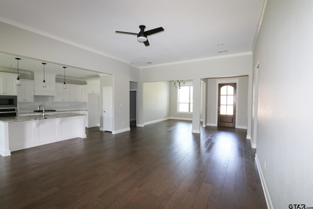 11747 Jayden Ln, Tyler, TX 75703 - unfurnished living room featuring a ceiling fan, dark wood-style floors, and crown molding