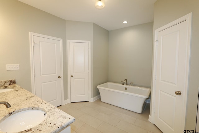 11747 Jayden Ln, Tyler, TX 75703 - full bathroom with a freestanding tub, double vanity, and tile patterned flooring